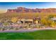 Breathtaking views of a custom home on the golf course with striking mountain backdrop at 2430 S Geronimo Head Trl, Gold Canyon, AZ 85118