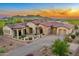 Impressive desert home showcasing stone accents, a red tile roof, and meticulous landscaping at 2430 S Geronimo Head Trl, Gold Canyon, AZ 85118