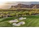 Aerial view of a golf course with sand bunkers and mountain views at 2430 S Geronimo Head Trl, Gold Canyon, AZ 85118