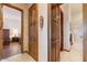 Hallway with marble floors leading to a bathroom and bedroom with light streaming in from a window at 2430 S Geronimo Head Trl, Gold Canyon, AZ 85118