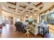 Spacious living room with a coffered ceiling, wood floors, a fireplace, and an open concept design at 2430 S Geronimo Head Trl, Gold Canyon, AZ 85118