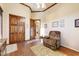 Inviting living room with hardwood floors, ceiling fan, and a comfortable reclining chair at 2430 S Geronimo Head Trl, Gold Canyon, AZ 85118