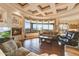 Bright living room with a fireplace, large windows offering mountain views, and comfortable seating arrangements at 2430 S Geronimo Head Trl, Gold Canyon, AZ 85118