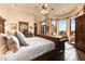 Lavish main bedroom showcases a large window, hardwood floors, and an elegant sitting area with abundant natural light at 2430 S Geronimo Head Trl, Gold Canyon, AZ 85118