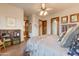 Spacious main bedroom features wood floors, ceiling fan, and decorative wood accents at 2430 S Geronimo Head Trl, Gold Canyon, AZ 85118