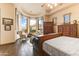 Bright and airy main bedroom with hardwood floors and a bay window providing views of the landscape at 2430 S Geronimo Head Trl, Gold Canyon, AZ 85118