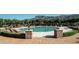 Inviting swimming pool surrounded by lounge chairs and lush landscaping at 2430 S Geronimo Head Trl, Gold Canyon, AZ 85118