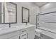 This bathroom features a double vanity, black hardware, a patterned tile floor, and a shower/tub combo at 2458 E Lark St, Gilbert, AZ 85297