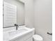 This powder room offers a white vanity with black hardware and light walls at 2458 E Lark St, Gilbert, AZ 85297