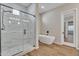 Bathroom featuring glass enclosed shower, soaking tub, and modern finishes at 2458 E Lark St, Gilbert, AZ 85297