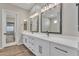 Bathroom featuring double sinks, quartz countertops, and modern fixtures at 2458 E Lark St, Gilbert, AZ 85297