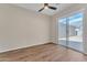 Bright bedroom with wood-look tile floor and a sliding glass door at 2458 E Lark St, Gilbert, AZ 85297