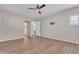 Spacious bedroom with wood-look tile flooring and ceiling fan at 2458 E Lark St, Gilbert, AZ 85297