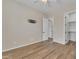 This bedroom has wood-look tile floors, and a mounted TV bracket with an adjacent door to the en-suite bathroom at 2458 E Lark St, Gilbert, AZ 85297