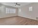 Minimalist bedroom with wood-look floors and plantation shutters for natural light at 2458 E Lark St, Gilbert, AZ 85297