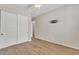 This bedroom has wood-look tile floors, a closet, and a mounted TV bracket on the wall at 2458 E Lark St, Gilbert, AZ 85297