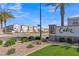 A welcoming community entrance with manicured landscaping, palm trees, and the 'Cadiz' neighborhood sign at 2458 E Lark St, Gilbert, AZ 85297