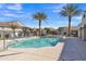 Refreshing community pool with lounge chairs and palm trees, offering a resort-like experience for residents at 2458 E Lark St, Gilbert, AZ 85297