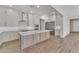 Contemporary kitchen with a large center island, marble countertops, and modern appliances at 2458 E Lark St, Gilbert, AZ 85297