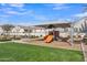 Community playground with modern equipment, sunshade, benches, and lush landscaping, perfect for Gathering enjoyment at 2458 E Lark St, Gilbert, AZ 85297