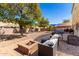 Cozy backyard features a fire pit, patio furniture, and ample space for outdoor entertaining at 2478 W Allens Peak Dr, San Tan Valley, AZ 85144