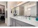 Bright bathroom featuring double sinks, a large mirror, and access to the shower and walk-in closet at 2478 W Allens Peak Dr, San Tan Valley, AZ 85144