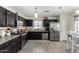 Well-equipped kitchen with stainless steel appliances, and adjacent dining area at 2478 W Allens Peak Dr, San Tan Valley, AZ 85144