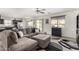 Spacious living room open to kitchen and dining area with modern ceiling fan at 2478 W Allens Peak Dr, San Tan Valley, AZ 85144