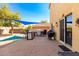 Spacious backyard patio with an outdoor kitchen, built-in grill, and shaded dining area at 2478 W Allens Peak Dr, San Tan Valley, AZ 85144