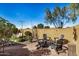 Inviting backyard with a seating area, lush greenery, and desert landscaping at 27044 W Escuda Dr, Buckeye, AZ 85396