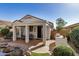 Serene backyard featuring a charming rock pond and covered patio at 27044 W Escuda Dr, Buckeye, AZ 85396