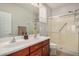 Bathroom featuring double sinks and walk-in shower at 27044 W Escuda Dr, Buckeye, AZ 85396