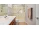 Bright bathroom featuring a glass-enclosed shower with grab bar and neutral tiling at 27044 W Escuda Dr, Buckeye, AZ 85396