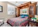 Bedroom featuring a cozy bed with a colorful quilt and built-in cabinets at 27044 W Escuda Dr, Buckeye, AZ 85396