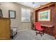 Bedroom featuring a comfy gray chair and built-in desk space at 27044 W Escuda Dr, Buckeye, AZ 85396