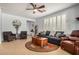 Inviting living room with a ceiling fan and stylish decor at 27044 W Escuda Dr, Buckeye, AZ 85396