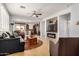 Open concept living room with fireplace, ceiling fan, and easy access to the kitchen at 27044 W Escuda Dr, Buckeye, AZ 85396