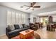 Comfortable living room featuring a ceiling fan, stylish furniture, and easy access to dining area at 27044 W Escuda Dr, Buckeye, AZ 85396