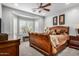 Comfortable main bedroom with bay window, ceiling fan, and stylish furnishings at 27044 W Escuda Dr, Buckeye, AZ 85396