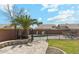 Private backyard with gated pool area, palm tree, and lounge furniture at 2755 E Cowboy Cove Trl, San Tan Valley, AZ 85143