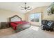 Spacious bedroom featuring vaulted ceiling, large windows, and a comfortable seating area at 2755 E Cowboy Cove Trl, San Tan Valley, AZ 85143