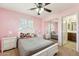 Pink bedroom with white furniture, plush decor, and ample natural light at 2755 E Cowboy Cove Trl, San Tan Valley, AZ 85143