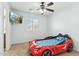 Fun bedroom with car-shaped bed, mounted TV, and natural light at 2755 E Cowboy Cove Trl, San Tan Valley, AZ 85143