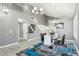 Open concept formal dining area with a glass table, plush rug, and designer chandelier at 2755 E Cowboy Cove Trl, San Tan Valley, AZ 85143