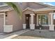 Inviting home exterior with a covered entrance, decorative columns, and lush landscaping at 2755 E Cowboy Cove Trl, San Tan Valley, AZ 85143