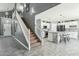 Staircase adjacent to an open kitchen design featuring stone countertops and eat-in island at 2755 E Cowboy Cove Trl, San Tan Valley, AZ 85143