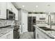 Modern kitchen showcasing white cabinets, granite countertops, and stainless steel appliances at 2755 E Cowboy Cove Trl, San Tan Valley, AZ 85143