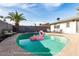 Relax in this inviting pool with a pink flamingo, surrounded by a landscaped backyard at 2801 N Dakota St, Chandler, AZ 85225