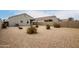 Backyard featuring gravel ground cover and mature desert landscaping, enclosed by block wall fencing at 29065 N Fire Agate Rd, San Tan Valley, AZ 85143