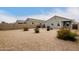 Backyard with gravel and sparse desert landscaping, enclosed by block walls for privacy at 29065 N Fire Agate Rd, San Tan Valley, AZ 85143